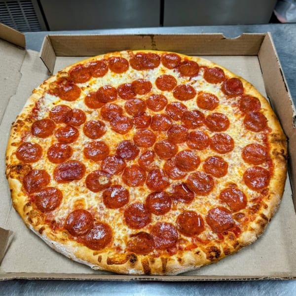 A freshly baked Shakey Jake's pepperoni pizza, hot and cheesy, in a cardboard delivery box.